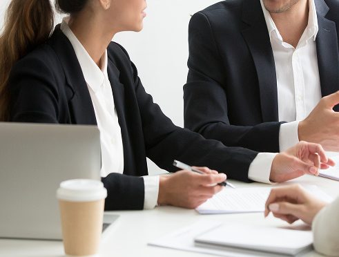 colleagues-discussing-business-strategy-office